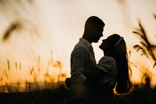 Couple Embracing at Dusk A couple embracing while out on a date at dusk.