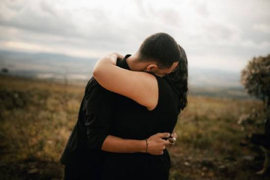 A couple embracing after forgiving each other.