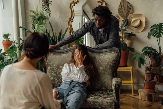 A couple going through a tough season attending a marital counseling session.