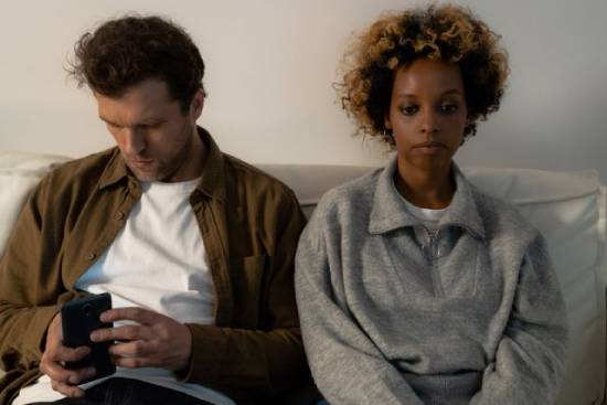 Emotionally Distant Couple Emotionally distant couple browsing in the living room.