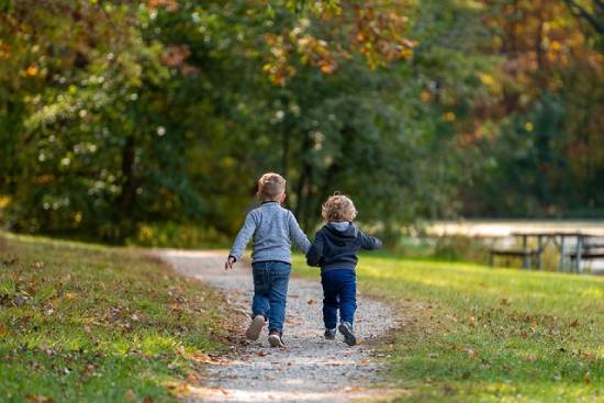Young Friends Walking Young friends walking together while holding hands.