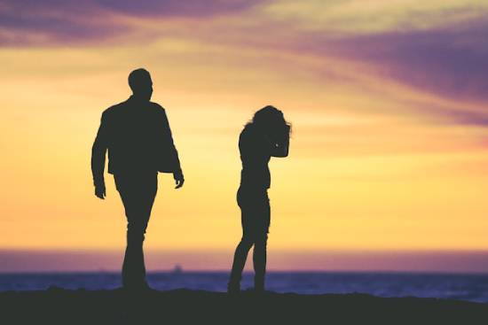 Silhouette of a Couple Under Yellow Sky Silhouette of a couple under a yellow sky during the golden hour.