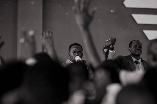 Men Praying Together Men holding hands and lifting them together during prayer