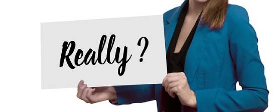 Woman Holding a Questioning Card A woman holding a card with expressions of question 'really?'